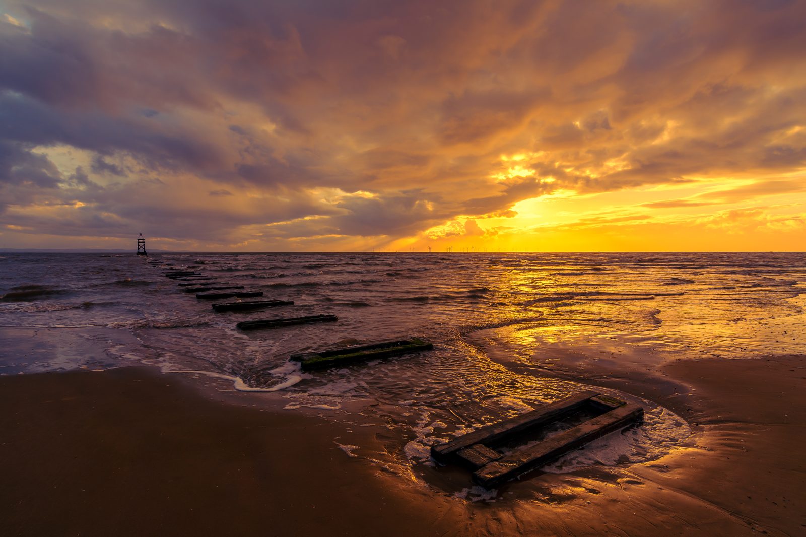 Golden sunset over the incoming tide at Crosby beach