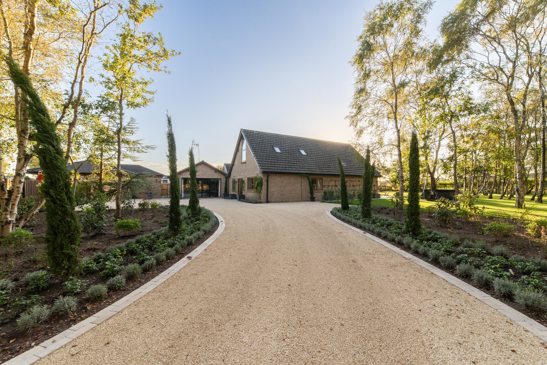 Warren House sweeping driveway with cypress trees