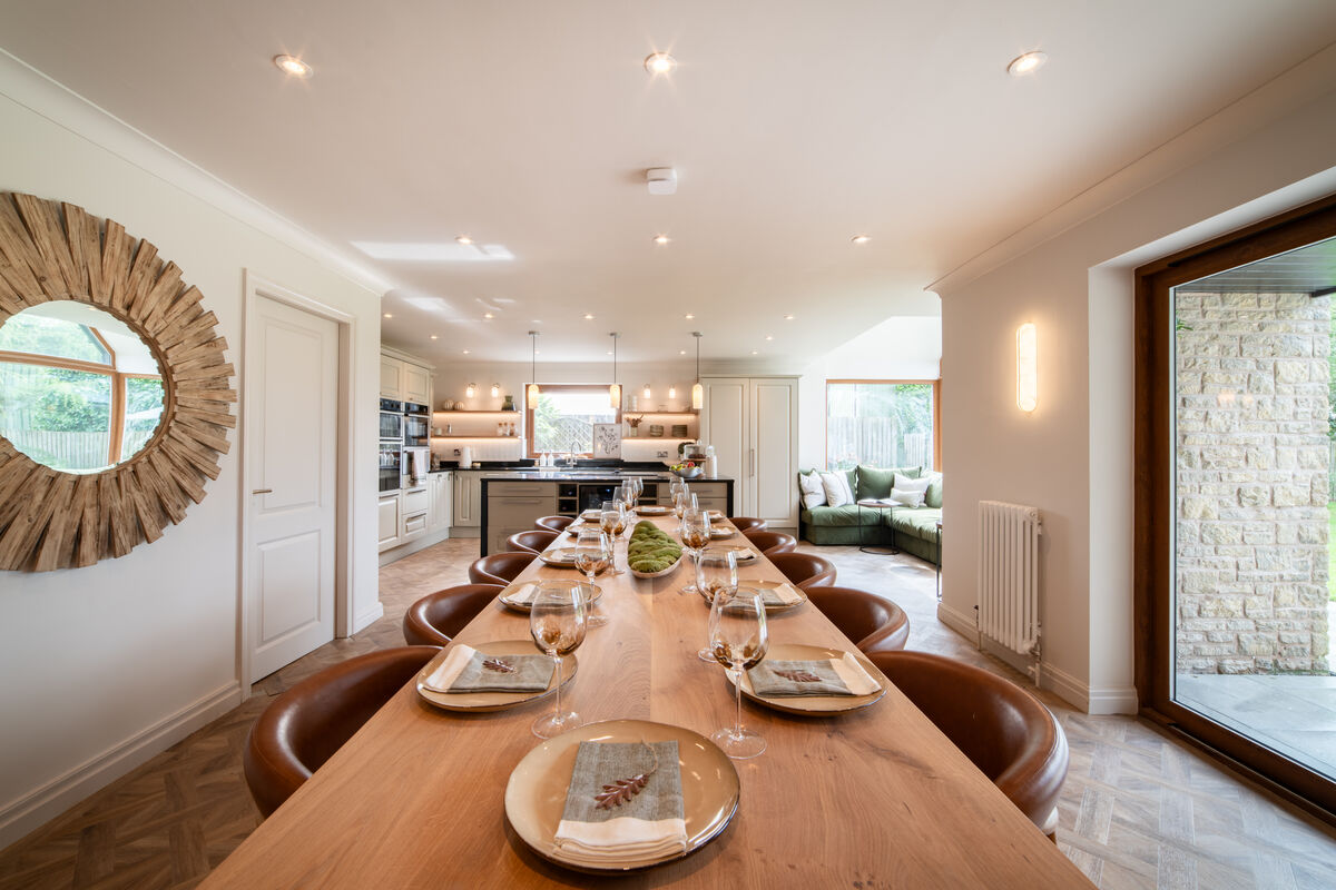 Dining table set for twelve with leather chairs and driftwood mirror