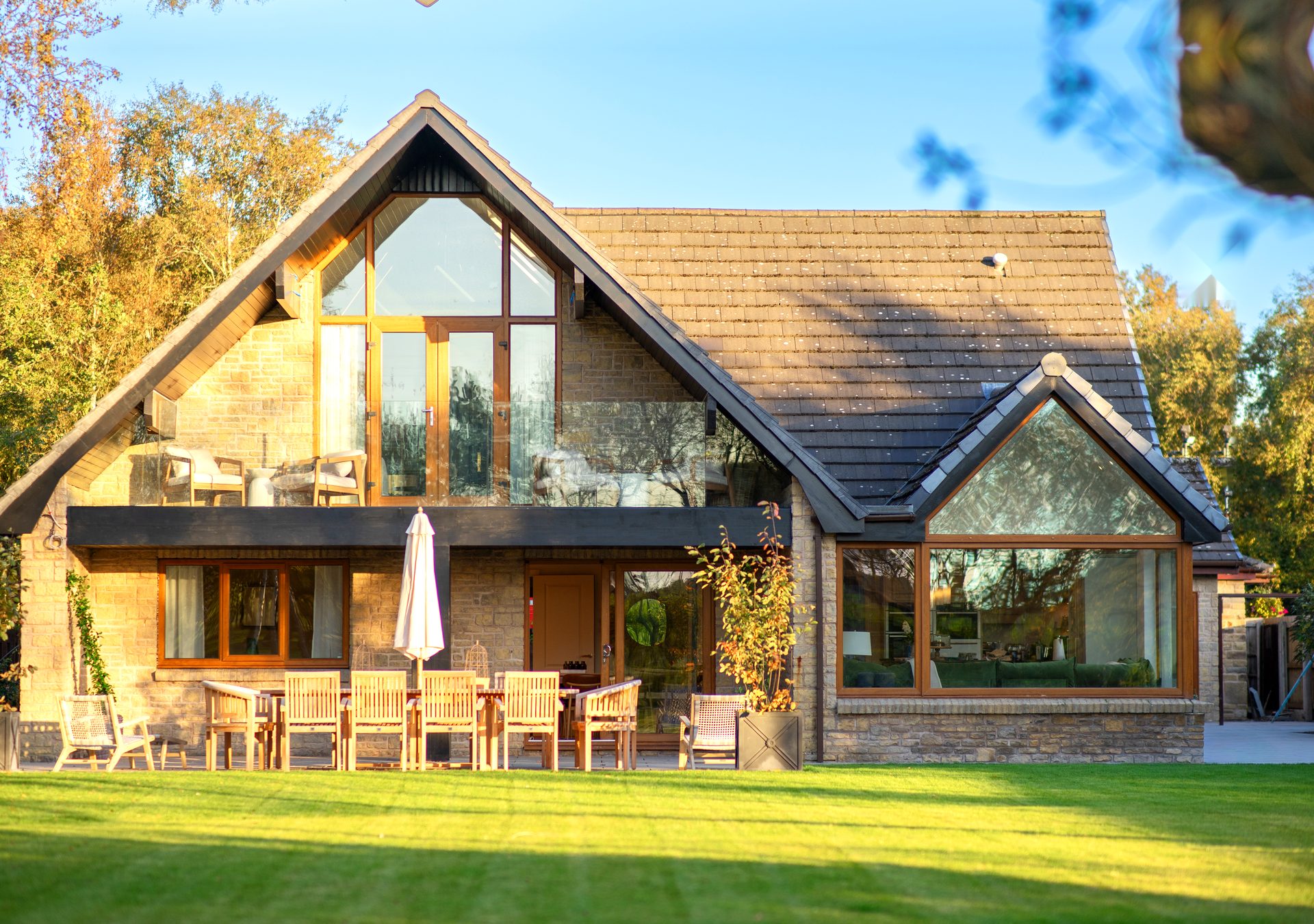 Warren House garden terrace and patio dining area in golden evening light