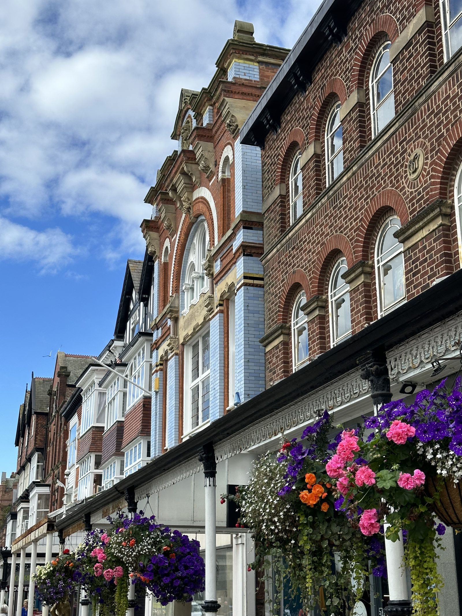 Victorian facades and hanging flower baskets on Lord Street, Southport