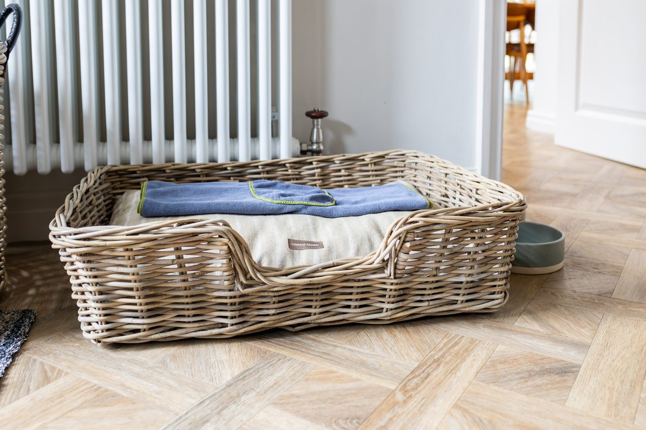 The wicker dog bed waiting in the boot room at Warren House