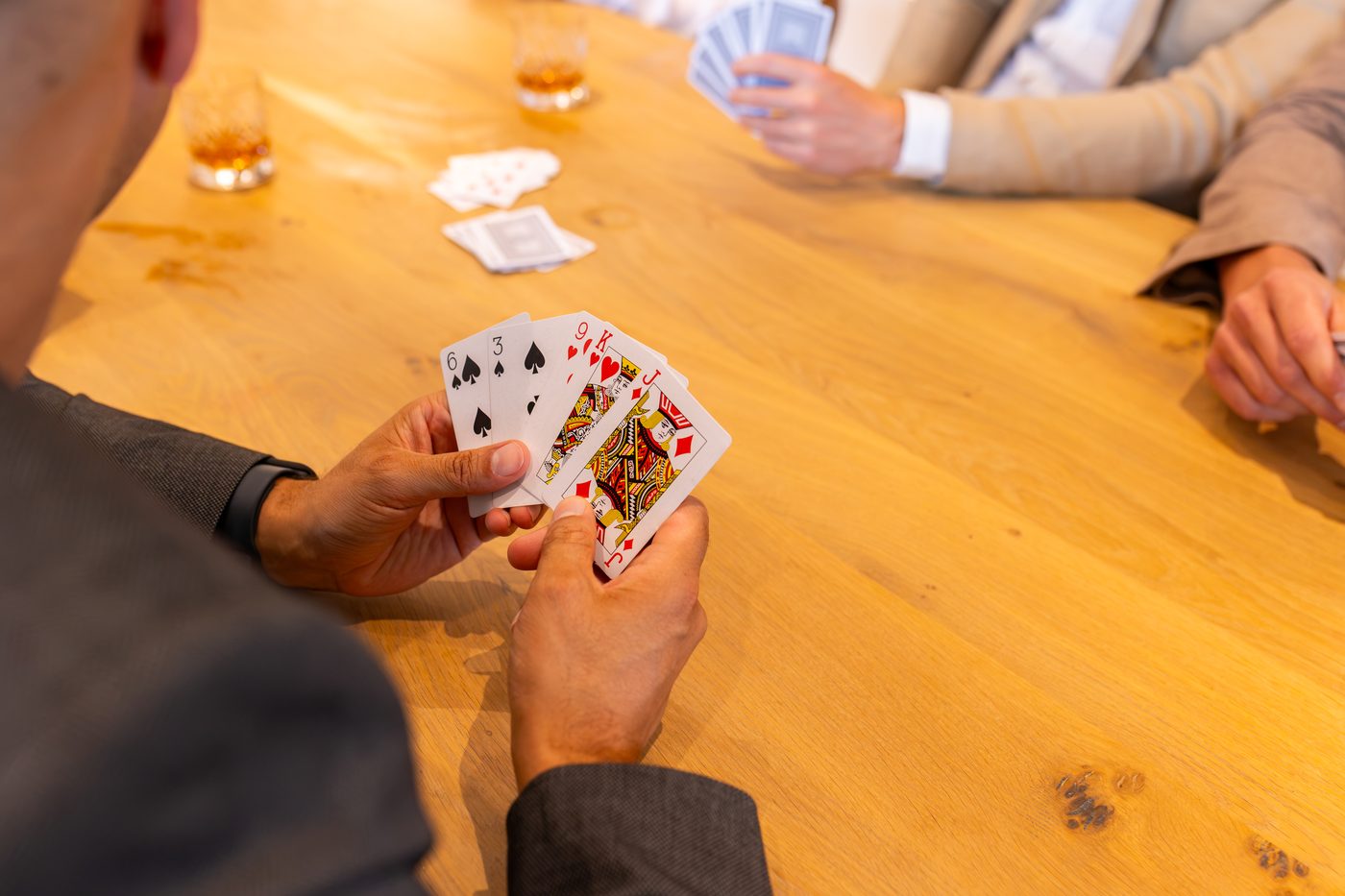 A hand of cards at the oak table at Warren House