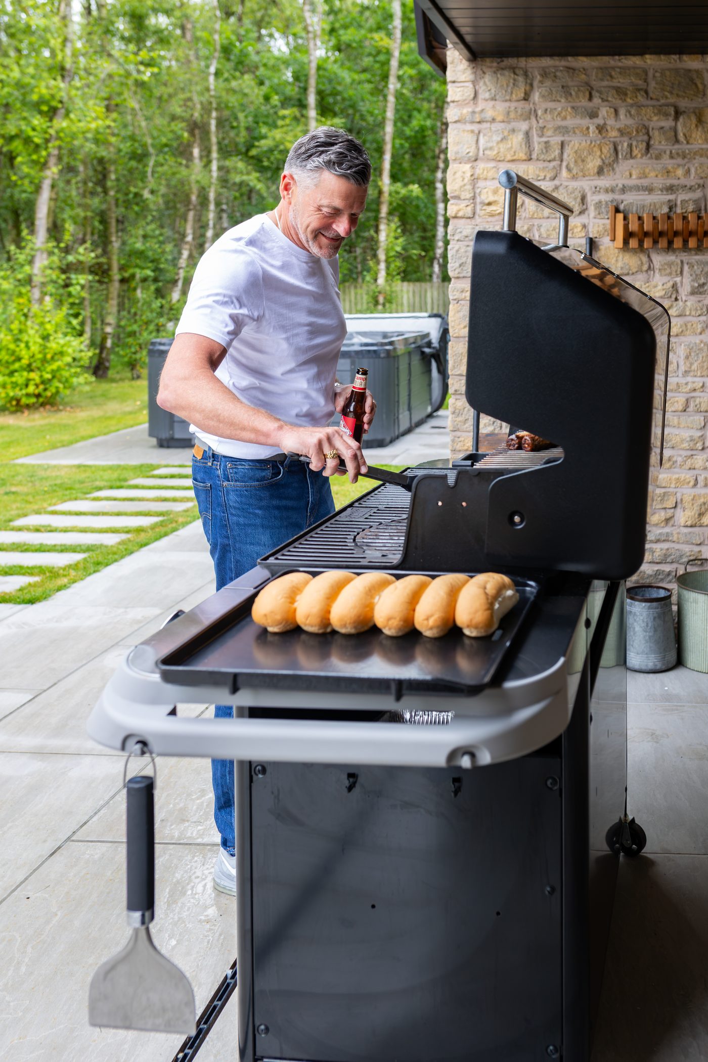 The built-in stone barbecue being fired up at Warren House