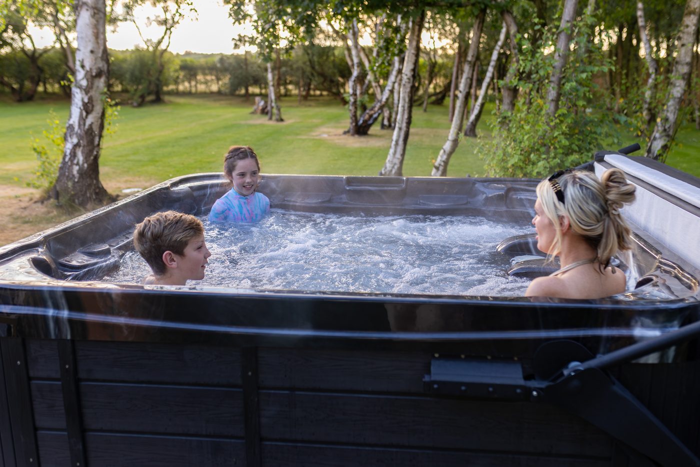 The family splashing about in the hot tub at Warren House