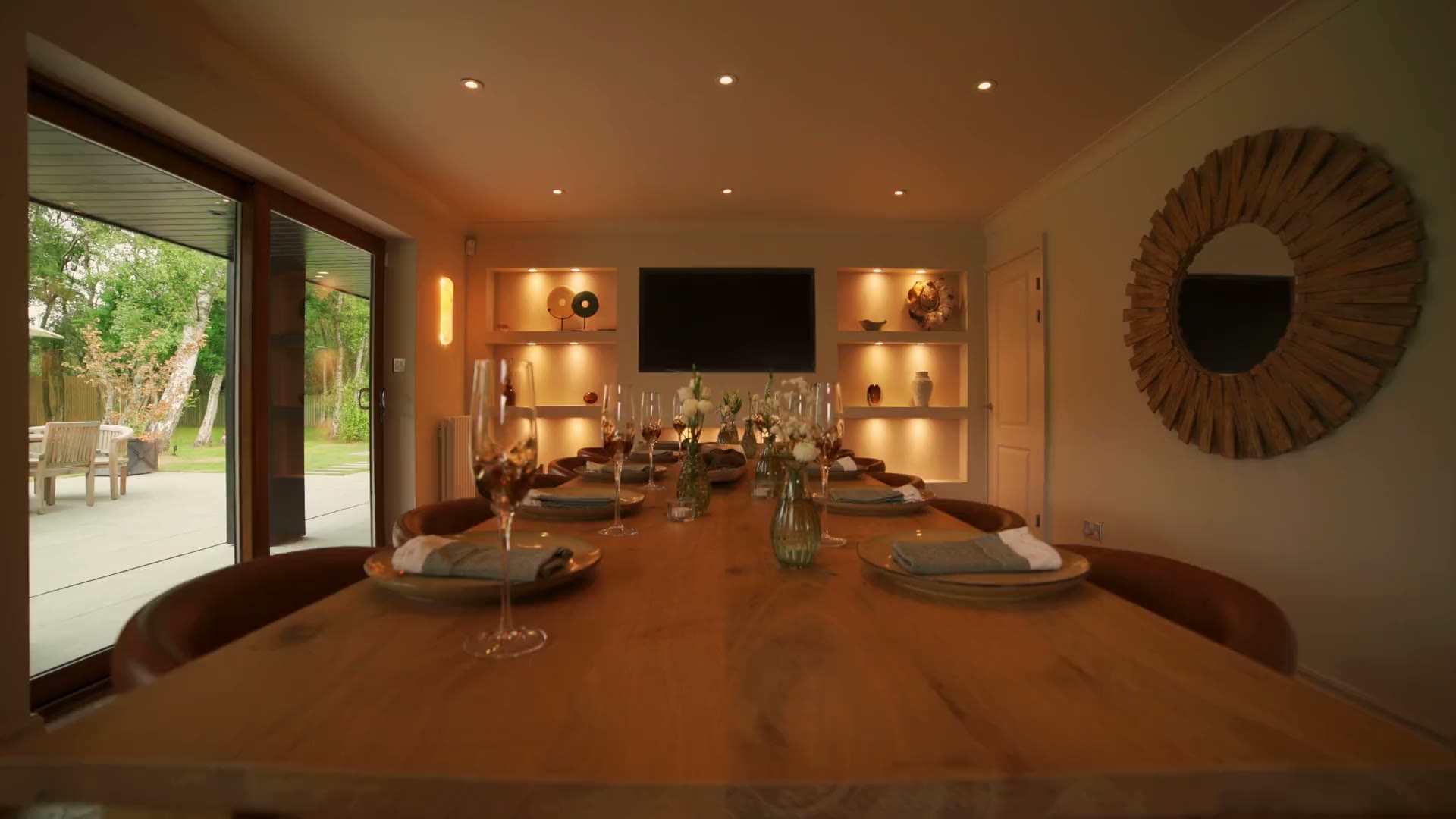 The dining table at Warren House, laid and glowing for dinner