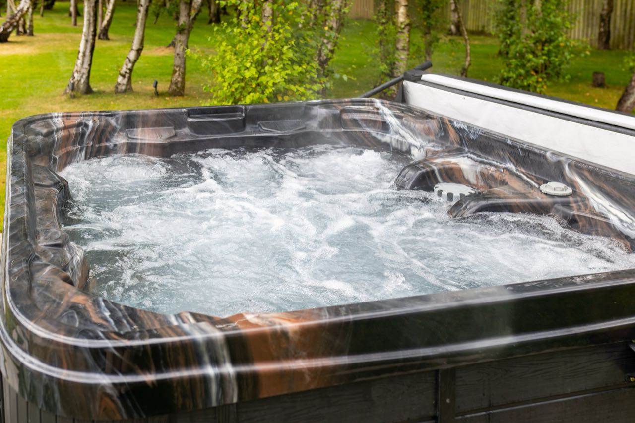 The hot tub at Warren House bubbling away among the silver birches