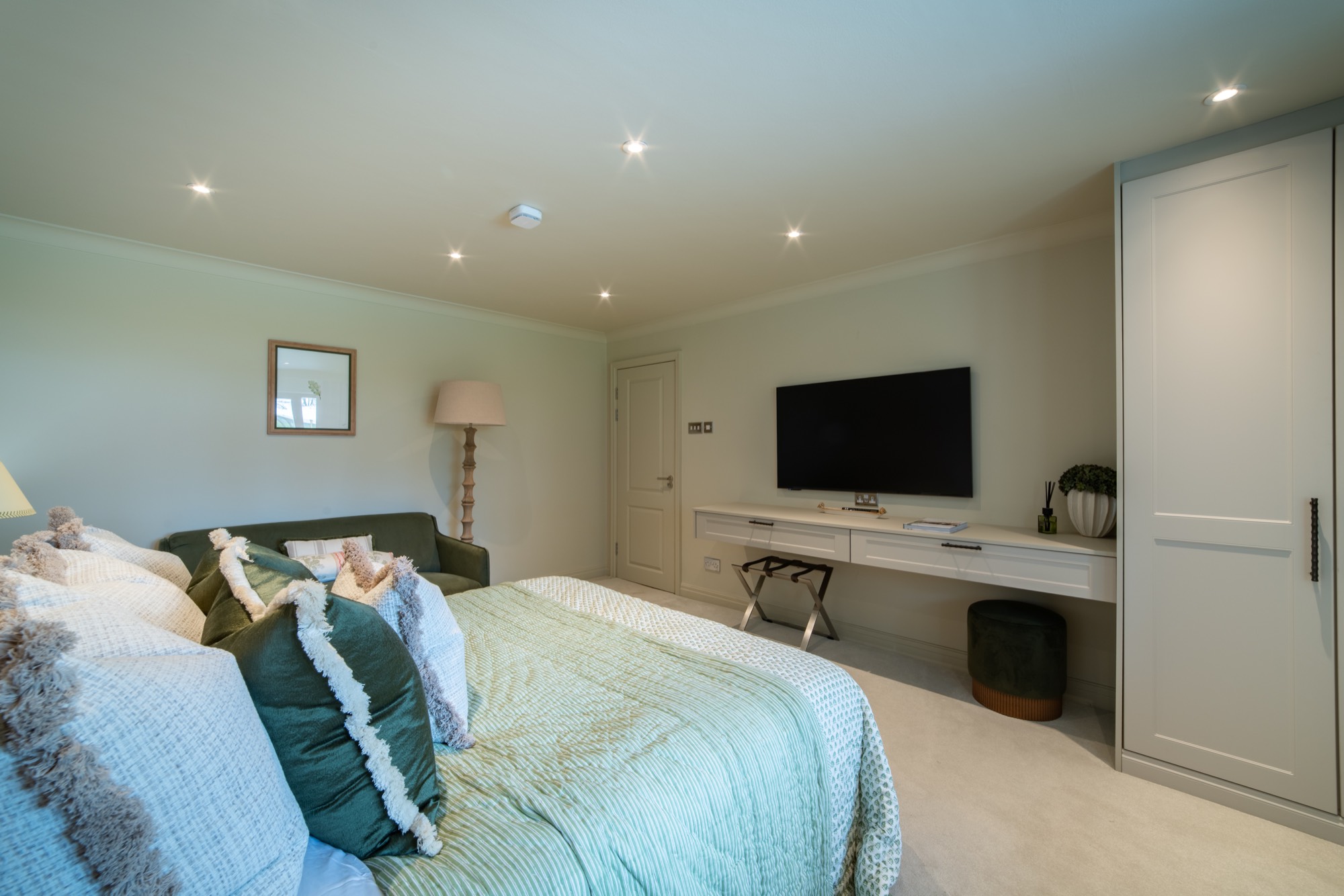 The Garden Room at Warren House, a large bedroom with a sofa, dressing area and garden views