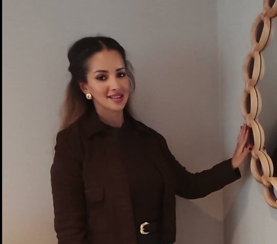 Sarah Ashcroft beside the arched mirror in the Dove Room at Warren House