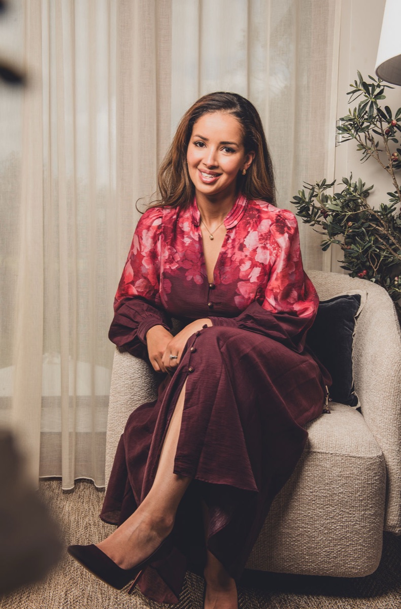 Sarah Ashcroft, interior designer of Warren House, smiling in one of her rooms