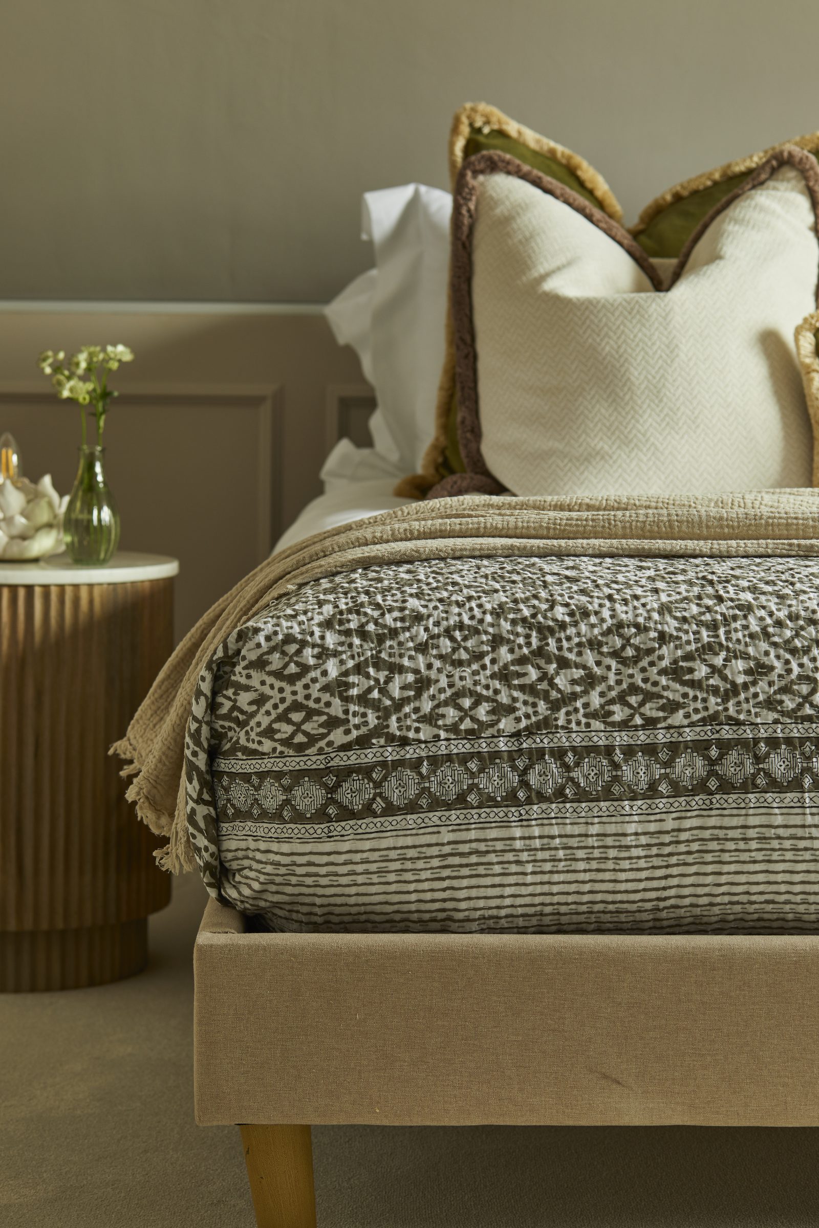Layered cushions and luxury bedding in a Warren House bedroom
